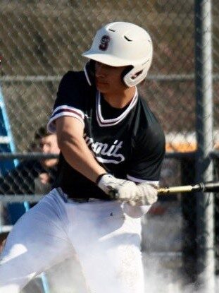 Baseball player swinging at a pitch during a game.