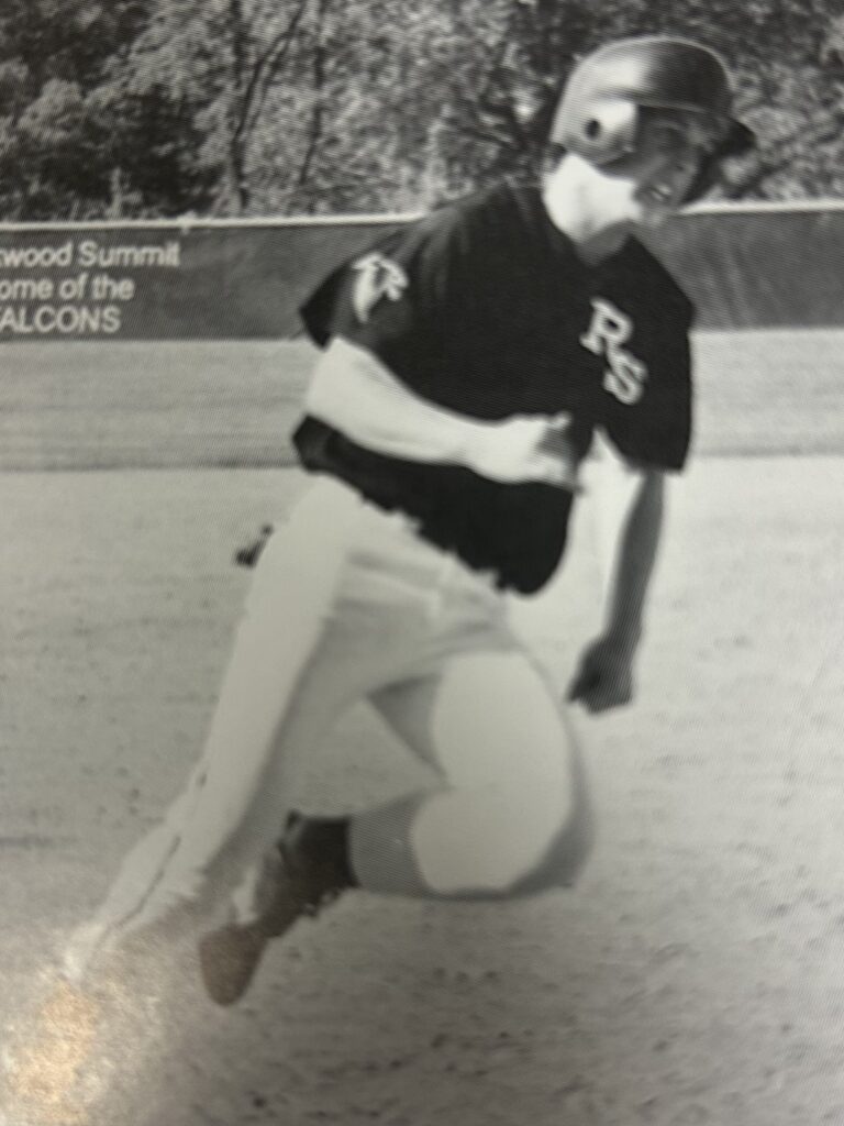 Black and white photo of a baseball player mid-pitch.
