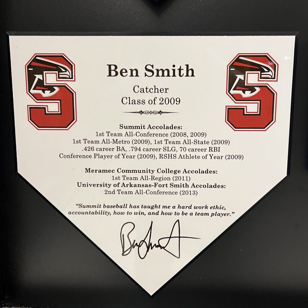 Baseball home plate plaque with player achievements and signatures.